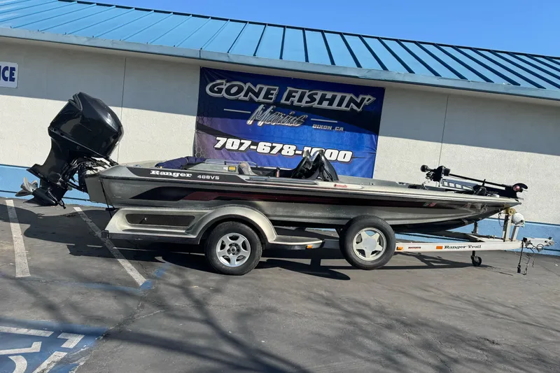 The Image of 1997 Ranger 488VS boat on trailer, parked outside a fishing store. - 1