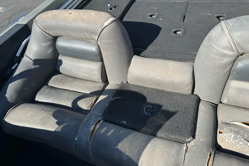 Slide: The Image of Worn interior seating of a 1997 Ranger 488VS boat, showing aged upholstery. - 17