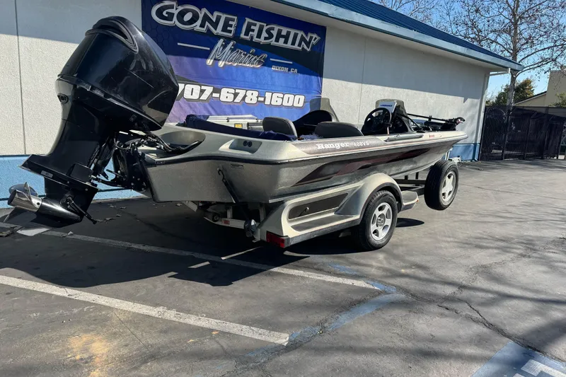 Slide: The Image of 1997 Ranger 488VS boat on trailer outside Gone Fishin' Marine dealership. - 2