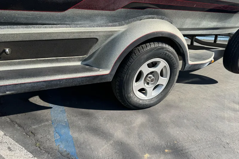 Slide: The Image of Trailer wheel of a 1997 Ranger 488VS boat on a parking lot. - 3