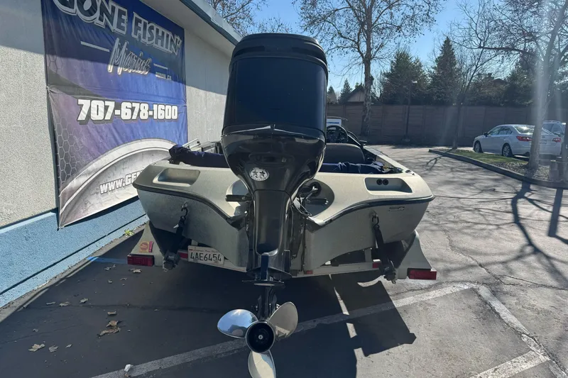 Slide: The Image of 1997 Ranger 488VS boat on trailer, parked near a fishing store. - 4