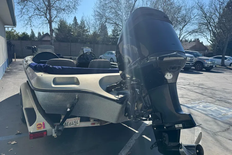 Slide: The Image of 1997 Ranger 488VS boat with powerful outboard motor in a parking lot. - 5