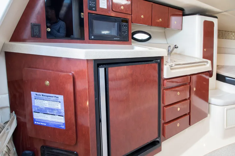 Slide: The Image of Interior of 2002 Wellcraft 3300 Martinique with kitchen and cabinets. - 10