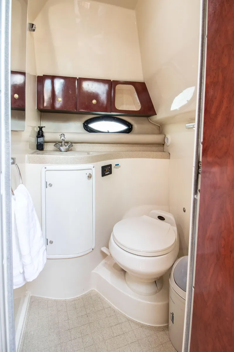Slide: The Image of Interior of 2002 Wellcraft 3300 Martinique, bathroom with toilet and sink. - 15
