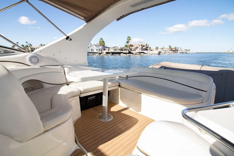 Slide: The Image of Interior of a 2002 Wellcraft 3300 Martinique yacht by the water. - 2