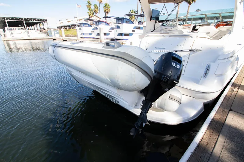 Slide: The Image of 2002 Wellcraft 3300 Martinique boat docked with outboard motor. - 20