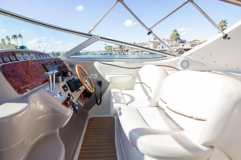 Slide: The Image of Interior of 2002 Wellcraft 3300 Martinique with helm and leather seating. - 3