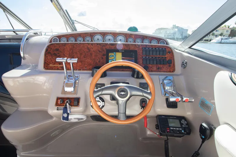 Slide: The Image of 2002 Wellcraft 3300 Martinique helm with wood steering wheel. - 4