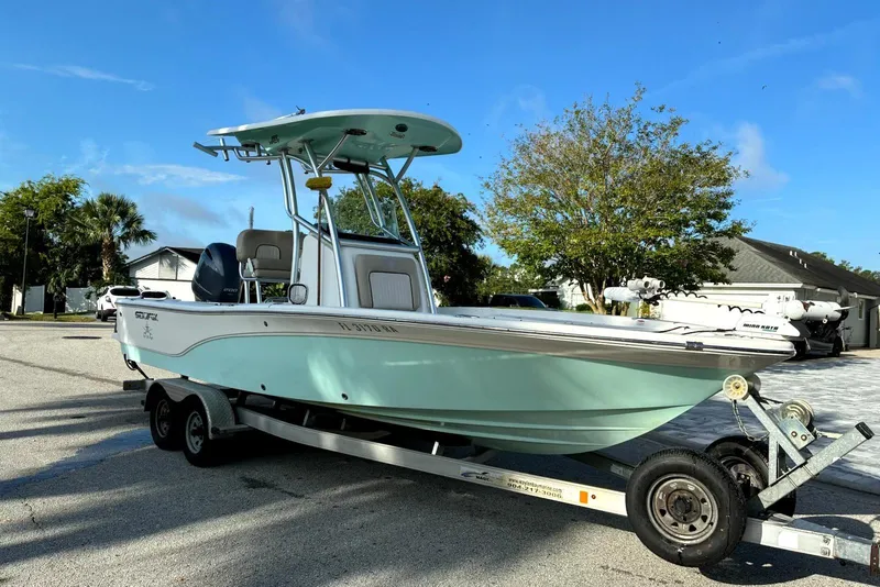 Slide: The Image of 2016 Sea Fox 220 Viper boat on trailer, parked outdoors under clear blue sky. - 2