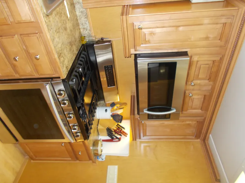 Slide: The Image of 2005 Sumerset Lake Bumz kitchen with wooden cabinets, stainless steel appliances, and granite countertops. - 17