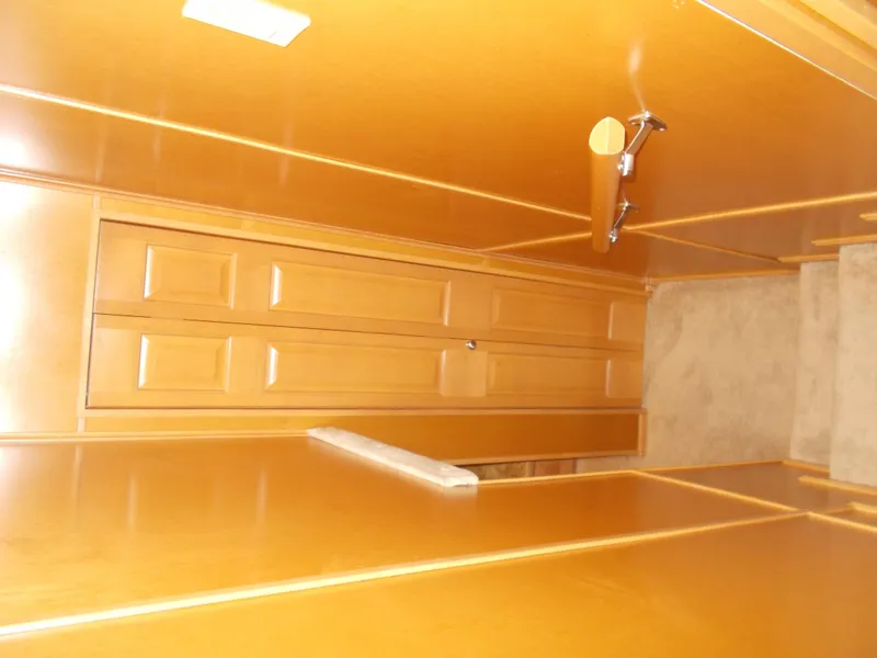 Slide: The Image of Interior hallway of 2005 Sumerset Lake Bumz houseboat with wooden paneling and carpeted stairs. - 22