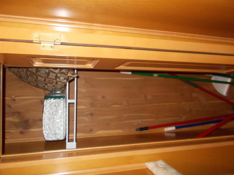 Slide: The Image of Wooden storage cabinet interior in a 2005 Sumerset Lake Bumz houseboat. - 24