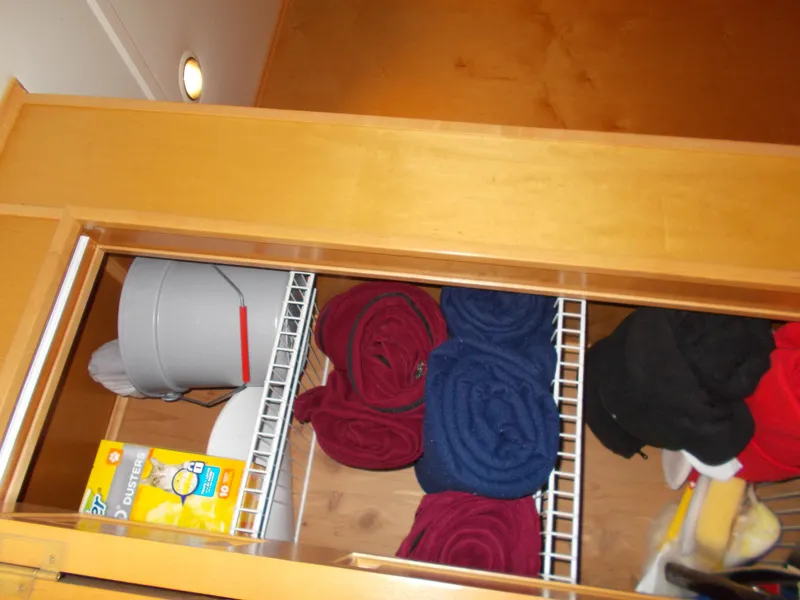 Slide: The Image of Storage closet in a 2005 Sumerset Lake Bumz houseboat with towels and cleaning supplies. - 25