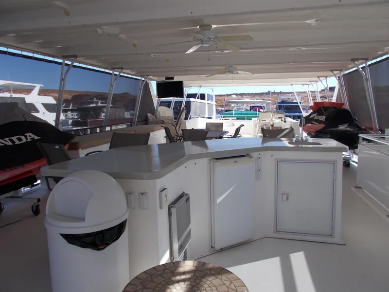 Slide: The Image of 2005 Sumerset Lake Bumz houseboat interior with kitchen and seating area. - 39