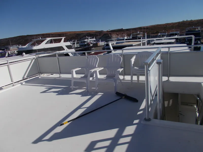 Slide: The Image of Top deck of 2005 Sumerset Lake Bumz houseboat with chairs and broom. - 45