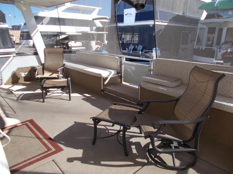 Slide: The Image of 2005 Sumerset Lake Bumz houseboat deck with chairs and seating area. - 8