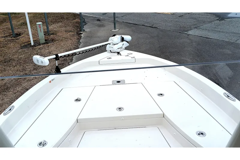 Slide: The Image of 2022 Ranger 2510 Bay boat deck with trolling motor, parked on pavement. - 10