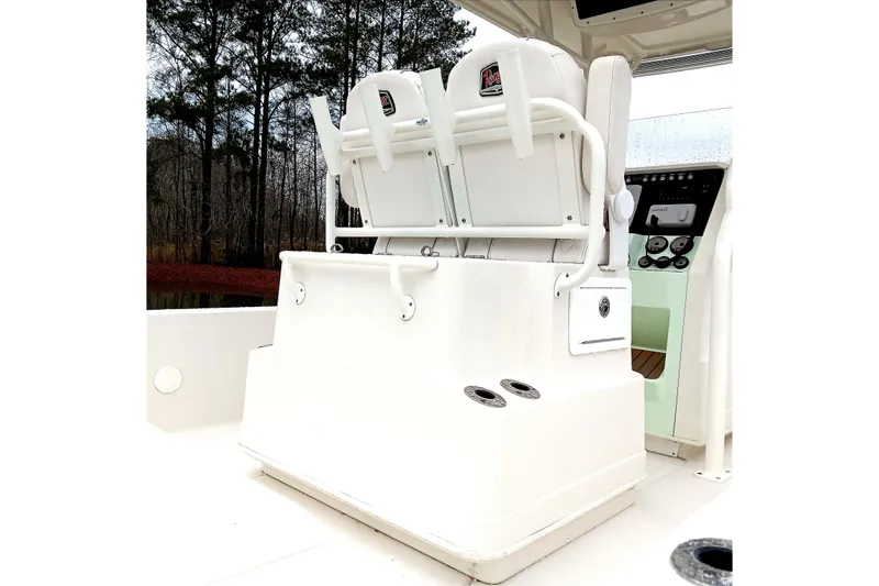 Slide: The Image of 2022 Ranger 2510 Bay boat interior with dual white seats and control panel. - 17