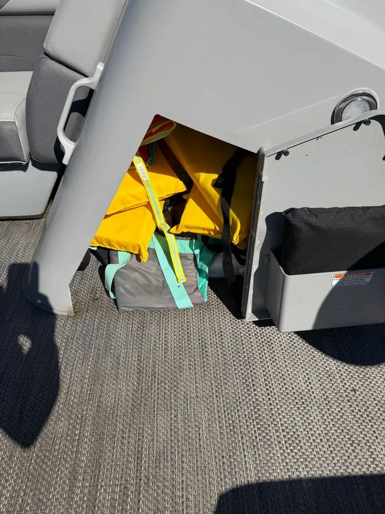 Slide: The Image of Storage compartment in Bennington SX 22 boat with yellow life jackets. - 19