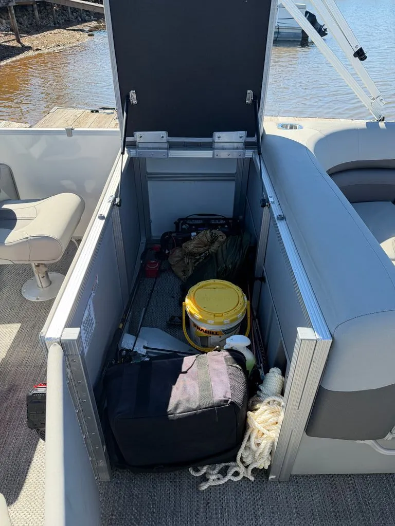 Slide: The Image of Storage compartment in Bennington SX 22 boat, filled with gear. - 23