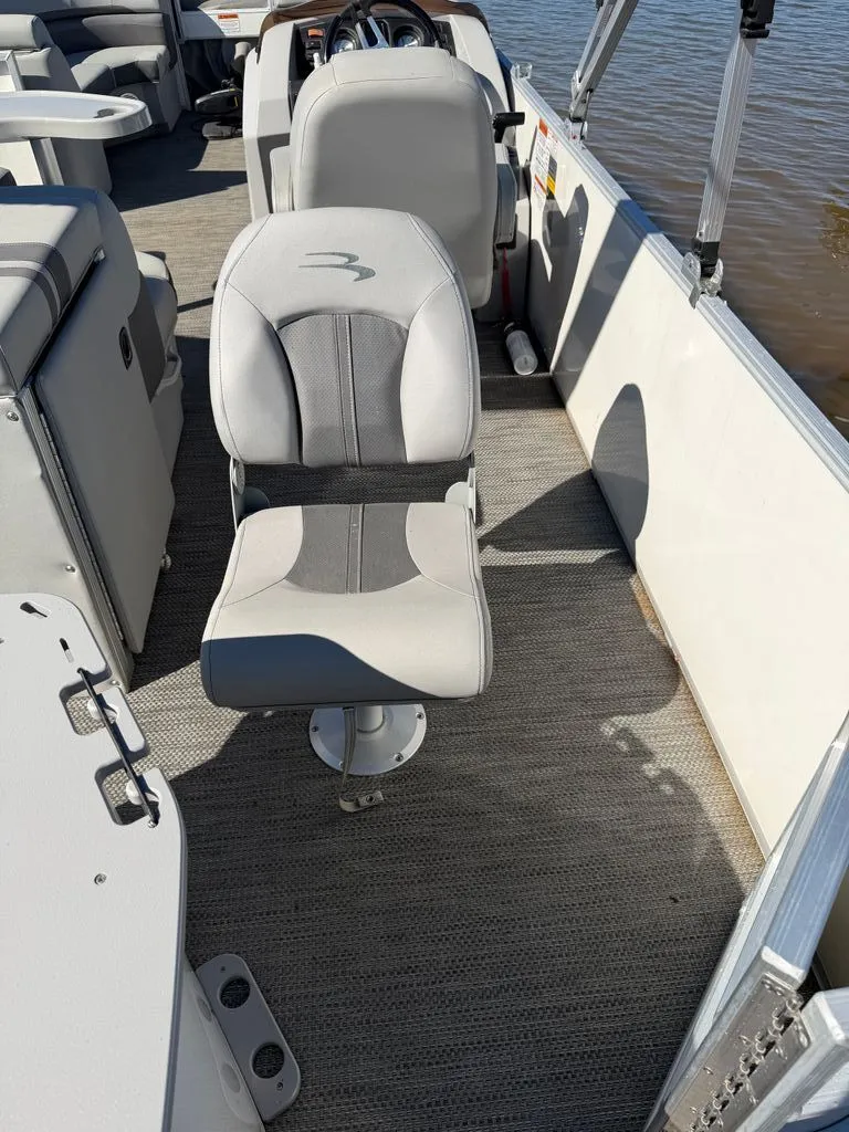 Slide: The Image of Interior of a 2023 Bennington SX 22 pontoon boat with gray seating. - 28