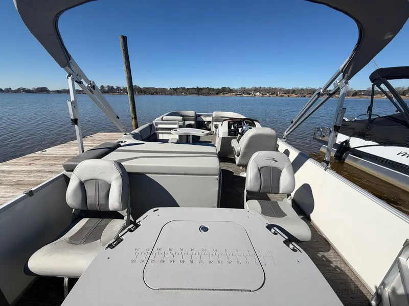 Slide: The Image of Interior view of a 2023 Bennington SX 22 pontoon boat at the dock. - 29