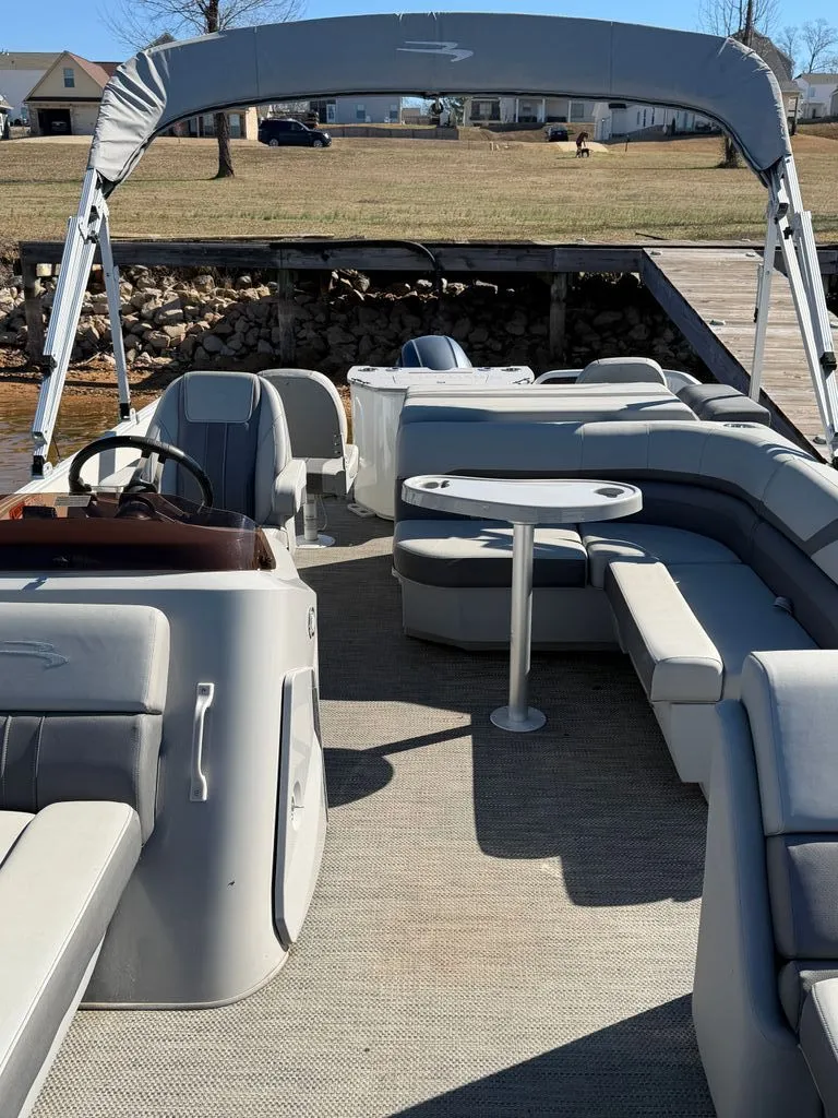Slide: The Image of Interior view of a 2023 Bennington SX 22 pontoon boat with seating area. - 31