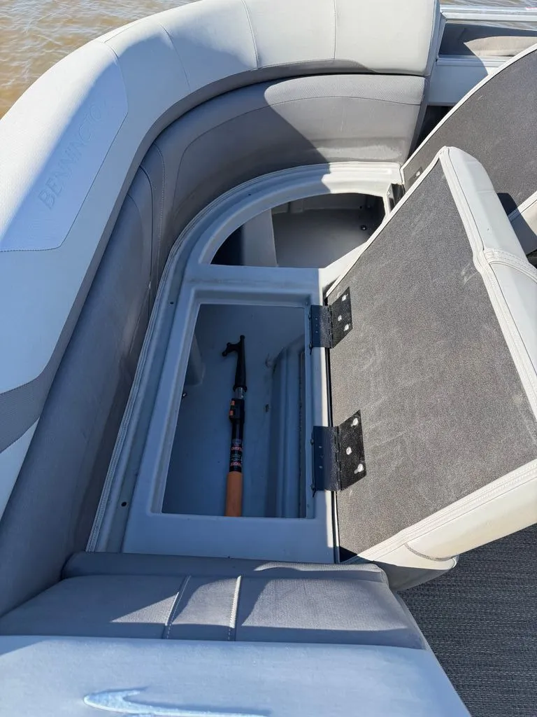 Slide: The Image of Bennington SX 22 boat with open storage compartment and fishing rod, 2023 model. - 6