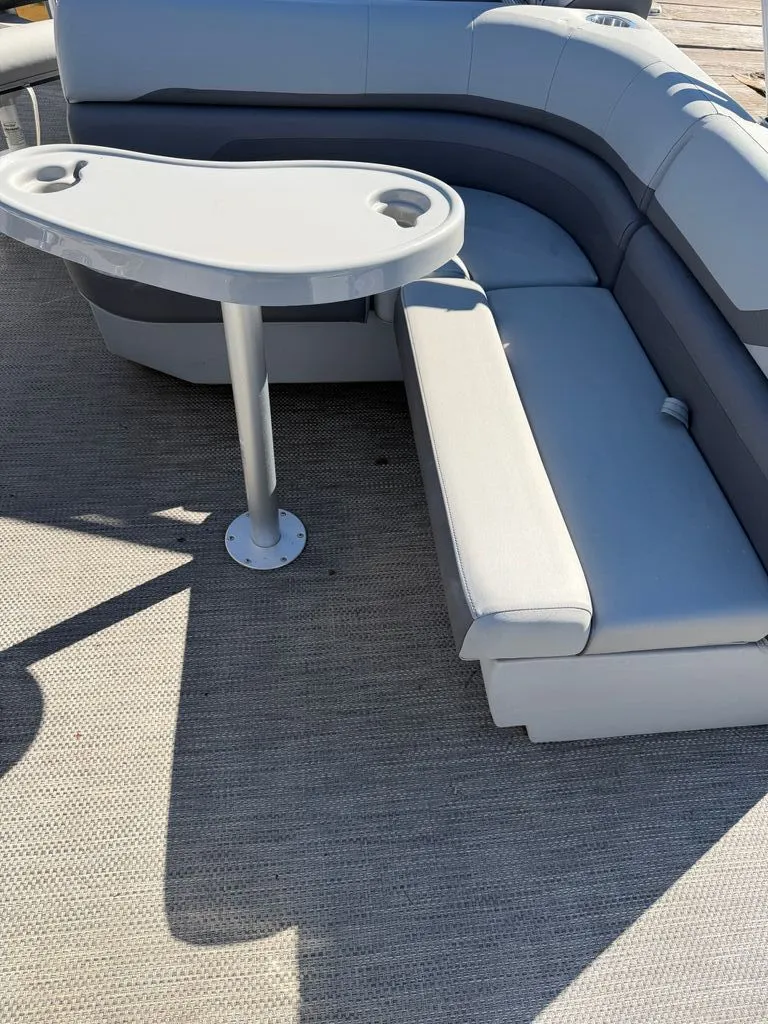 Slide: The Image of Interior of 2023 Bennington SX 22 with gray seating and table. - 7