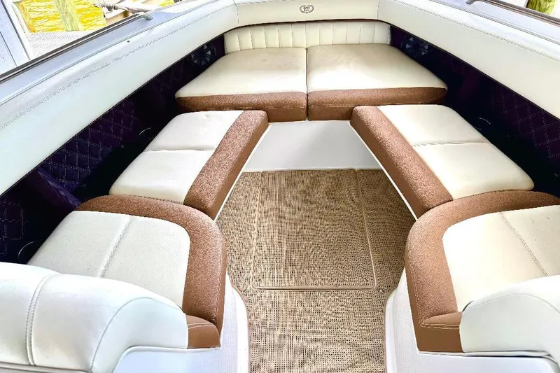 Slide: The Image of Luxurious interior seating of a 2016 Cobalt 302 boat with beige and brown upholstery. - 10