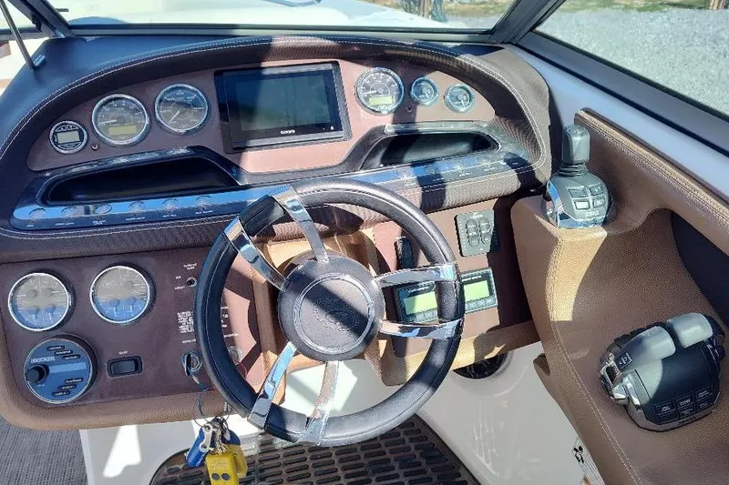 Slide: The Image of Dashboard of a 2016 Cobalt 302 boat with steering wheel and gauges. - 11