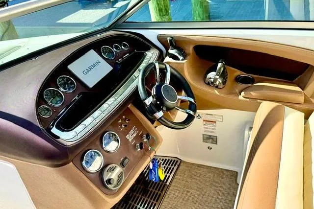 Slide: The Image of Interior of a 2016 Cobalt 302 boat with Garmin navigation system and sleek dashboard. - 12