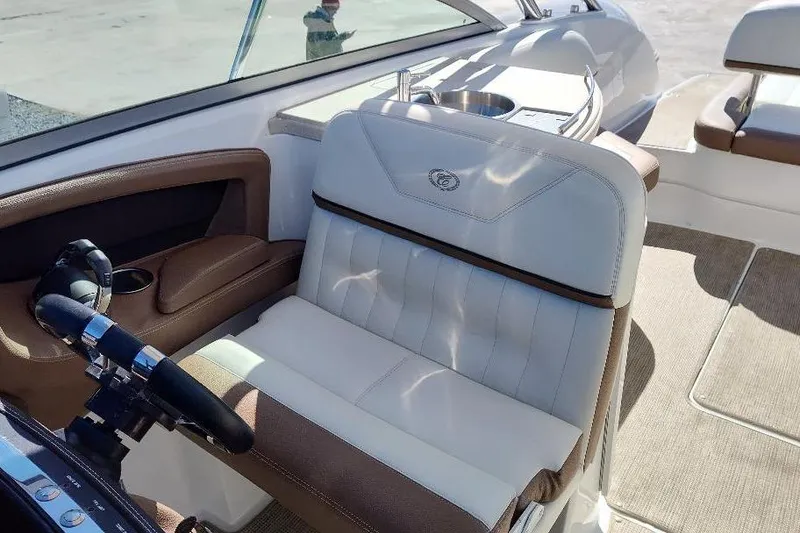 Slide: The Image of 2016 Cobalt 302 boat interior with luxurious seating and steering wheel. - 14