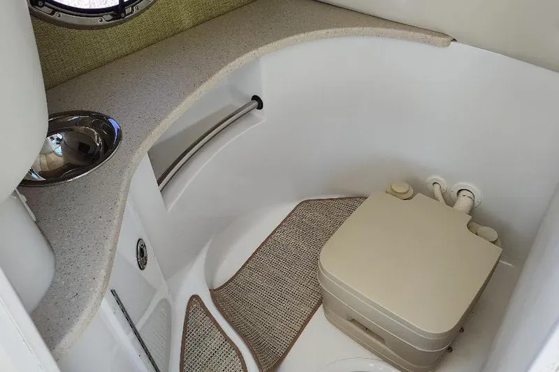 Slide: The Image of Compact bathroom in 2016 Cobalt 302 boat with sink and portable toilet. - 16