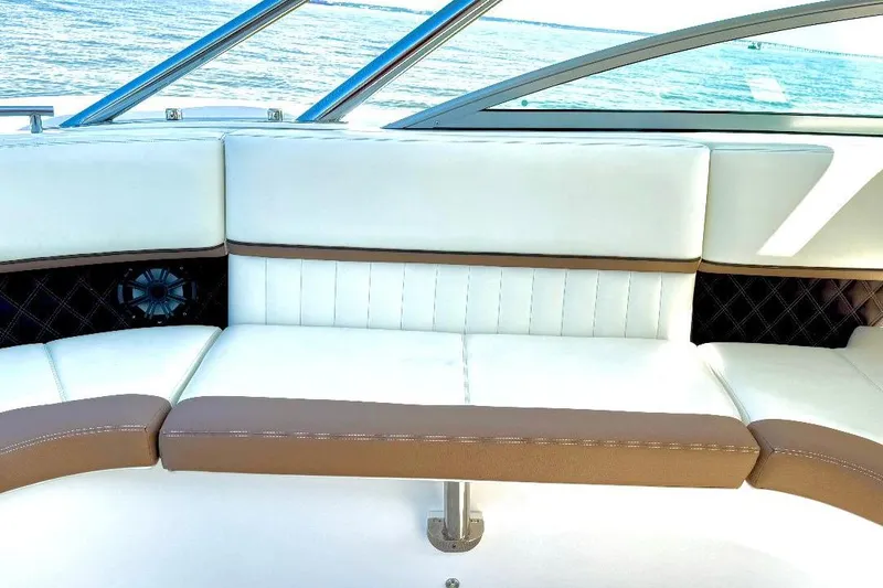 Slide: The Image of Luxurious seating on 2016 Cobalt 302 boat with white and brown upholstery. - 19