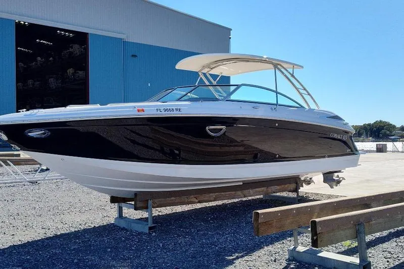 Slide: The Image of 2016 Cobalt 302 boat on display outside a blue warehouse. - 2