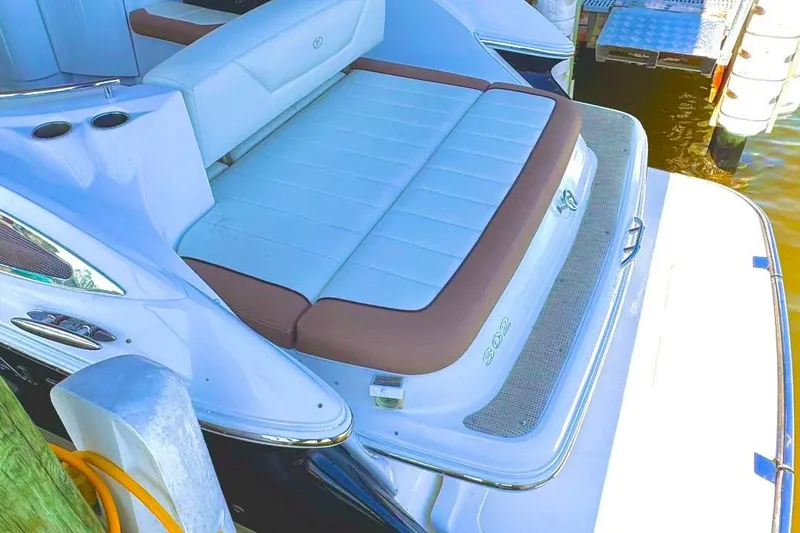 Slide: The Image of 2016 Cobalt 302 boat with cushioned seating and swim platform at dock. - 30