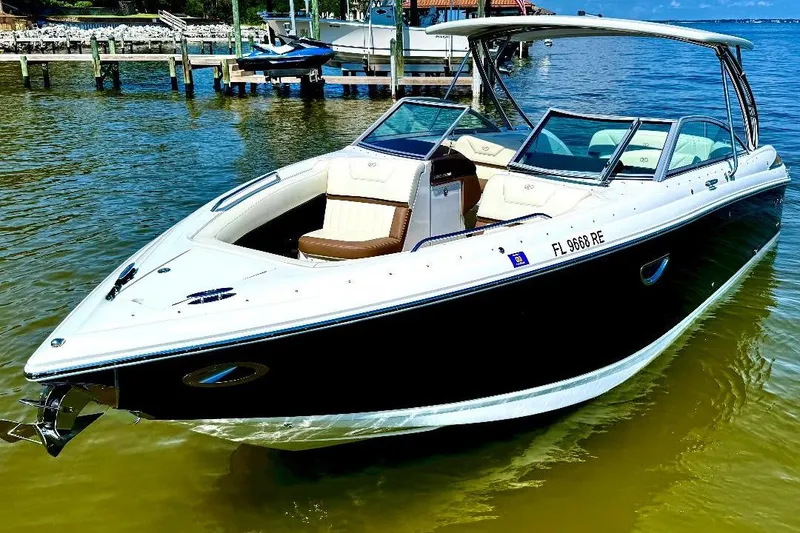 Slide: The Image of 2016 Cobalt 302 boat docked on calm water, featuring sleek design and comfortable seating. - 5