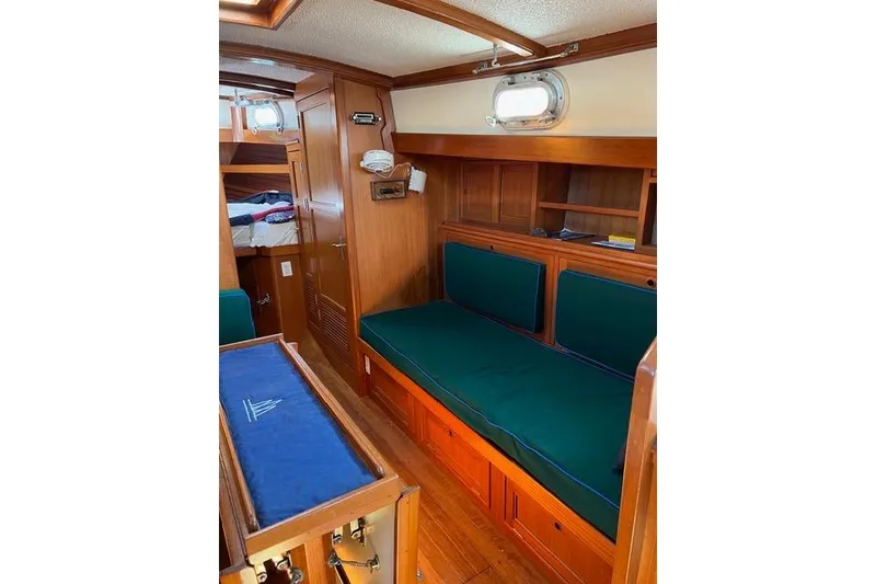 Slide: The Image of Interior of 1977 Fuji 45 MK II Ketch with wooden furnishings and green cushions. - 3
