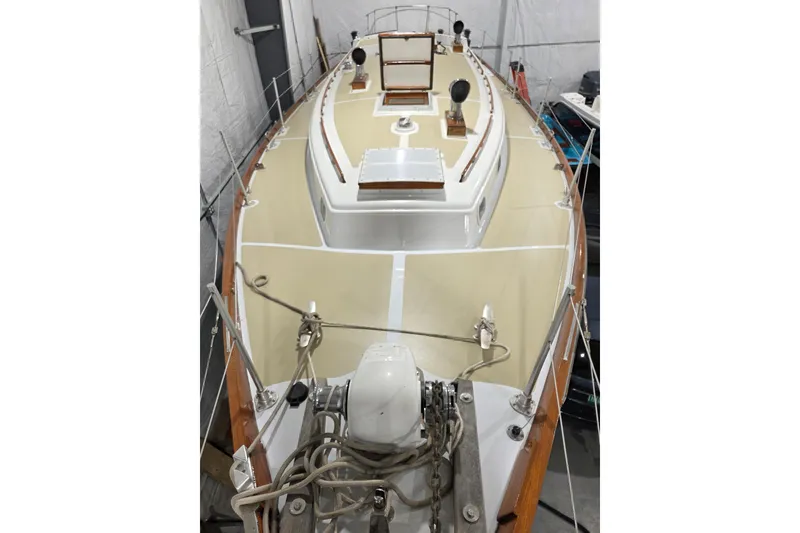 Slide: The Image of 1977 Fuji 45 MK II Ketch sailboat in storage, showcasing deck and rigging details. - 30