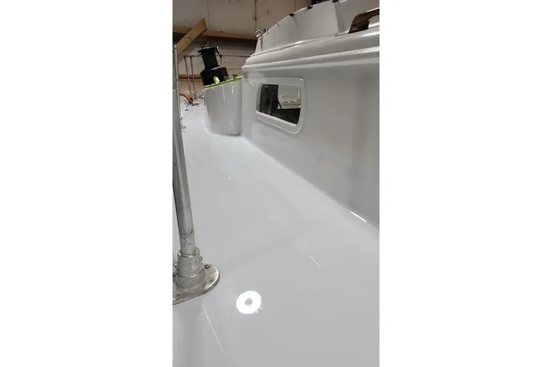 Slide: The Image of 1977 Fuji 45 MK II Ketch deck, showcasing sleek white surface and window detail. - 35