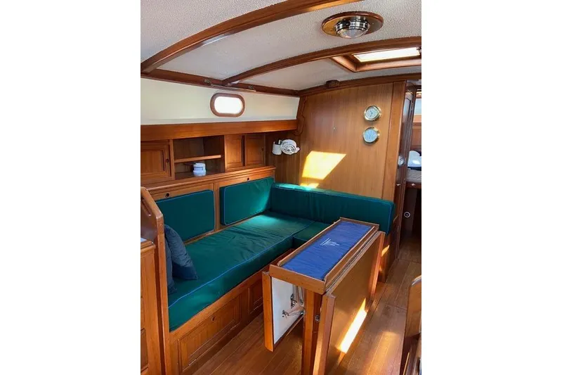 Slide: The Image of Interior of 1977 Fuji 45 MK II Ketch with wooden furnishings and green seating. - 4
