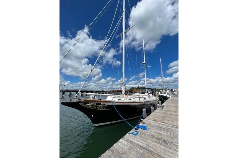Slide: The Image of 1977 Fuji 45 MK II Ketch docked under a bright blue sky. - 57