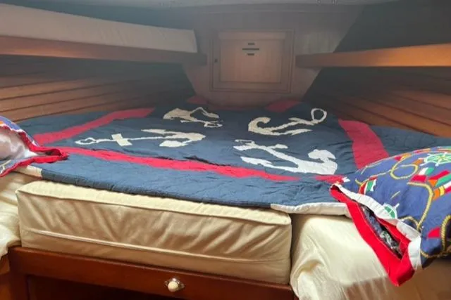 Slide: The Image of Interior of a 1977 Fuji 45 MK II Ketch with anchor-themed bedding. - 6