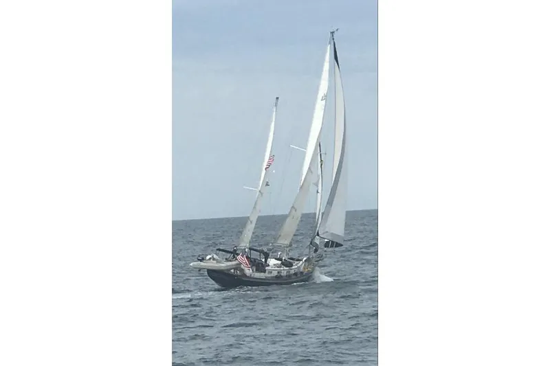 Slide: The Image of 1977 Fuji 45 MK II Ketch sailing on open sea with full sails. - 62