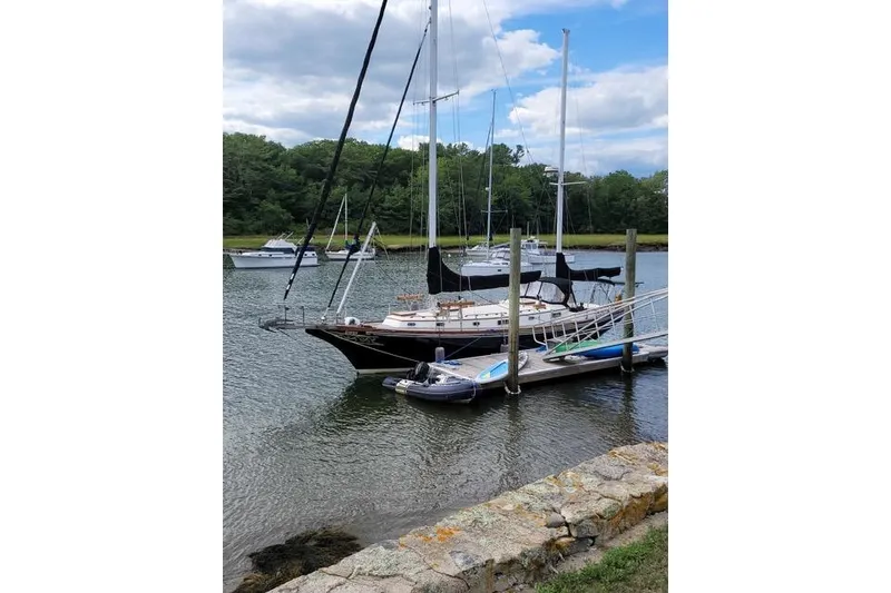 Slide: The Image of 1977 Fuji 45 MK II Ketch docked in a serene marina setting. - 63