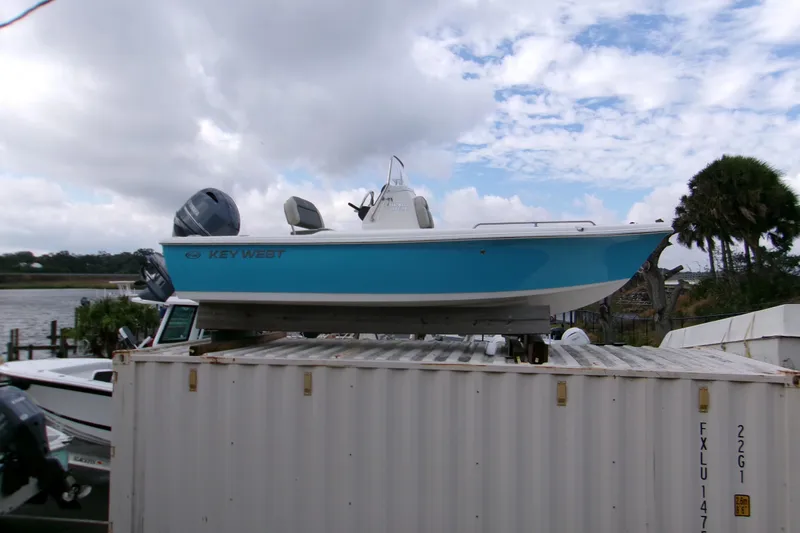 The Image of 2026 Key West 1720 Center Console boat displayed on a forklift outdoors. - 0