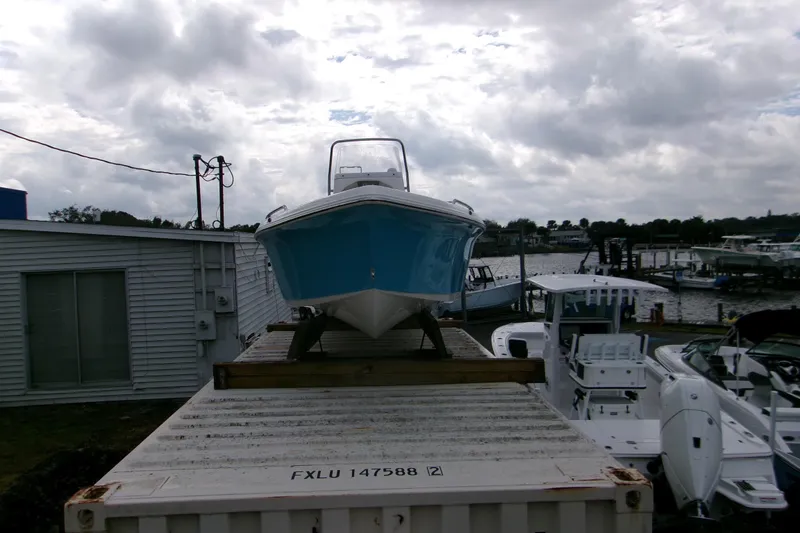 Slide: The Image of 2026 Key West 1720 Center Console boat on display at a marina, cloudy sky backdrop. - 20