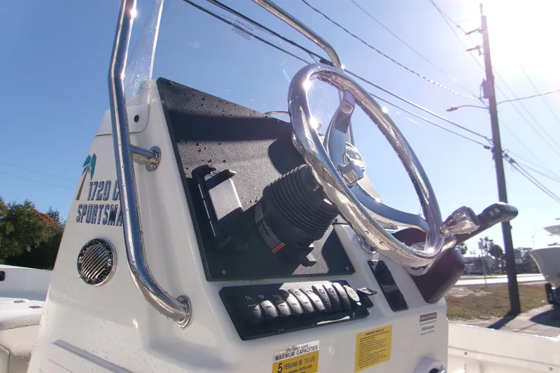 Slide: The Image of 2026 Key West 1720 Center Console boat steering wheel and dashboard in sunlight. - 23