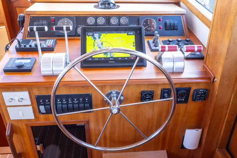 Slide: The Image of Helm of 2002 Sabreline 47 yacht with navigation equipment and steering wheel. - 3